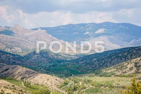 Panoramic views of valley, forests, hills and mountains Stock Photos