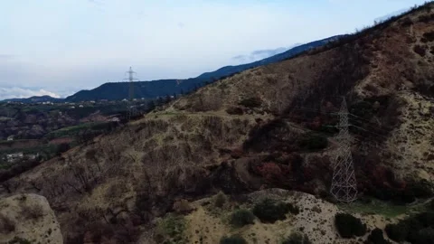 Panoramic wildfire altered mountain slope with dual power transmission towers Stock Footage 344096769