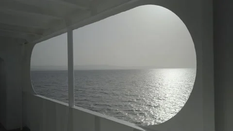 A panoramic window on a ferry reveals the calm, blue Mediterranean Sea Stock Footage 238845575