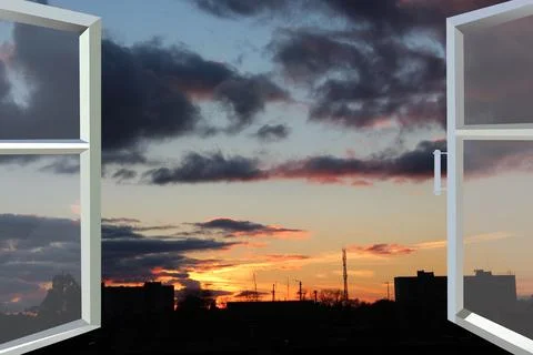 Panoramic window overlooking the evening city. Twilight in city Stock Photos