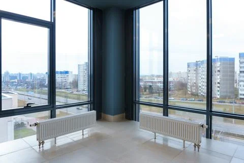 Panoramic windows in an empty spacious room. Installation of fiberglass windo Stock Photos