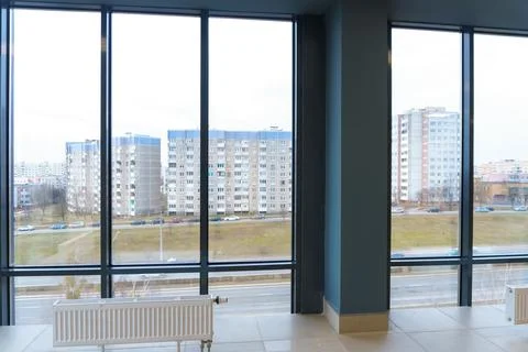Panoramic windows in an empty spacious room. Installation of fiberglass windo Stock Photos
