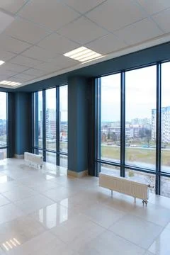 Panoramic windows in an empty spacious room. Installation of fiberglass windo Stock Photos