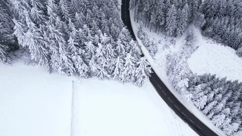 Panoramic winter drone view of the mountains in the forest. Asphalt road Stock-Footage 231906294