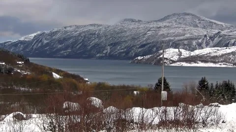 Panoramic Winter Landscape View of Snow-Covered Mountains and Fjord Stock Footage 310323440