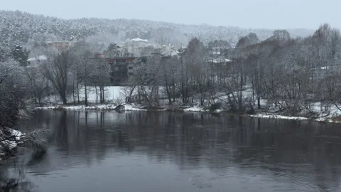 Panoramic winter view of snowy river from bridge during snowfall in Vilnius Stock Footage 260076912