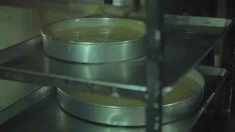 Pans of cake rotating in a large walk in oven Stock Footage 231414656