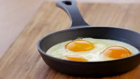 Pans eggs, black cast pan,Smokes, new cooked,Dolly shot , extreme close up ,4k C Stock Footage