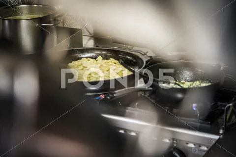 Pans Of Food Cooking On Stove