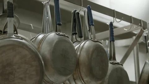 Pans hanging in a restaurants kitchen  Stock Footage 79832390