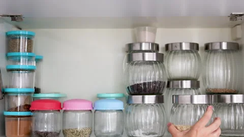 Pantry, storage organization many jars with grains food for sugar salt Stock Footage 247174191