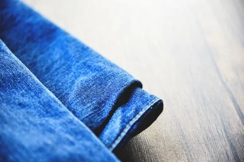 Pants folded jeans pattern / Fabric Used of blue jeans on wooden background 스톡 사진