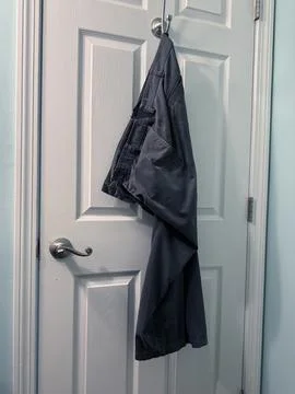 Pants hanging on hook Stock Photos