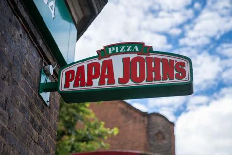 A Papa Johns logo sign outside a restaurant in London Stock Photos