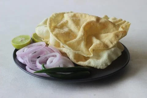 A papadum also called papad is a thin, crisp, round flatbread from India Foto stock