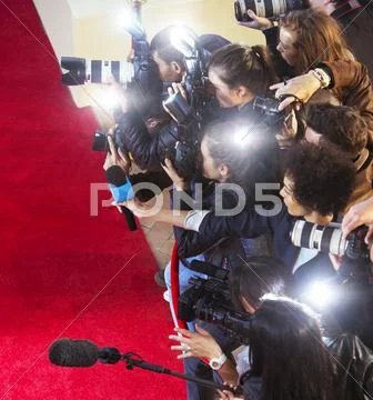 Paparazzi photographers photographing at red carpet event Stock Photos