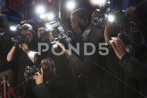 Paparazzi using flash photography at red carpet event Stock Photos