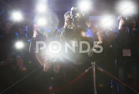 Paparazzi using flash photography at red carpet event Stock Photos