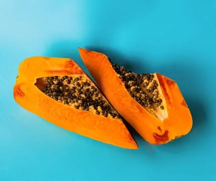 Papaya on a blue background Stock Photos