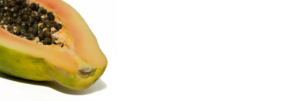 Papaya cut in half on a white background. Juicy sweet fruit. Healthy food con Stock Photos