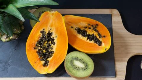 The papaya is cut into two halves Stock Photos