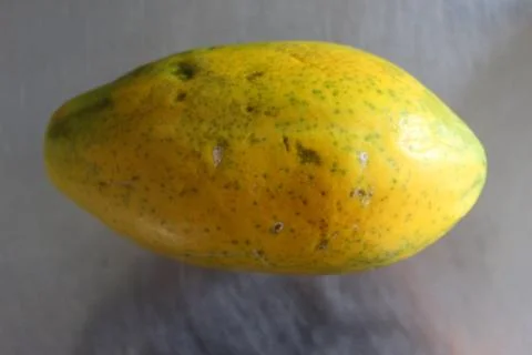 Papaya fruit on the kitchen table. Stock Photos