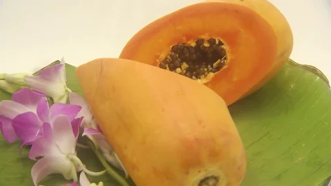 Papaya on white background rotating with blender and papaya smoothie Stock Footage 118772989