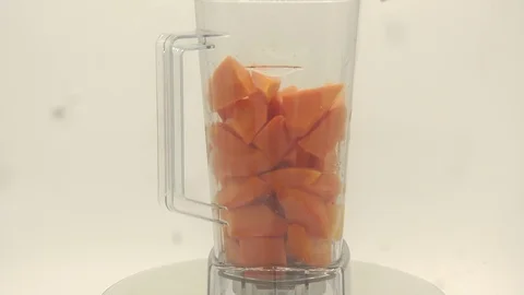 Papaya on white background rotating with blender and papaya smoothie Stock Footage 118773272