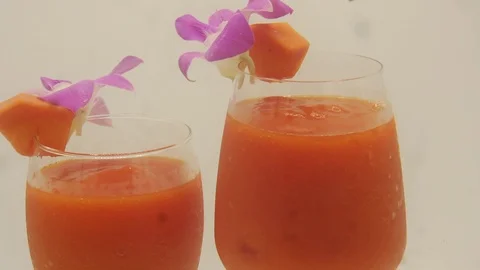Papaya on white background rotating with blender and papaya smoothie Stock Footage 118773436