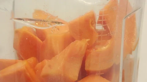 Papaya on white background rotating with blender and papaya smoothie Stock Footage 118773503