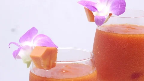 Papaya on white background rotating with blender and papaya smoothie Stock Footage 118773634