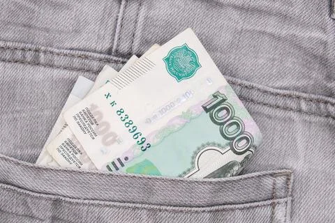 Paper 1000 banknotes of russian rubles in a jeans pocket, inflation rate concept Stock Photos