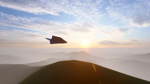 Paper airplane flying over clouds and mountains facing the sun Stock Footage 316525797