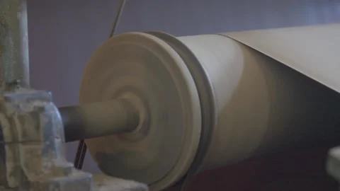 Paper and pulp mill processes a huge sheet of cardboard. An industrial mechanism Stock Footage 232422034