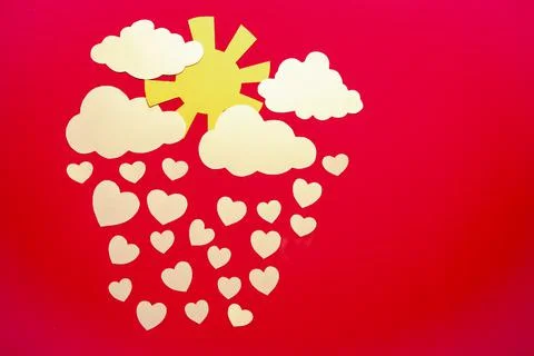 Paper application - clouds with the sun from which white hearts are falling. 스톡 사진