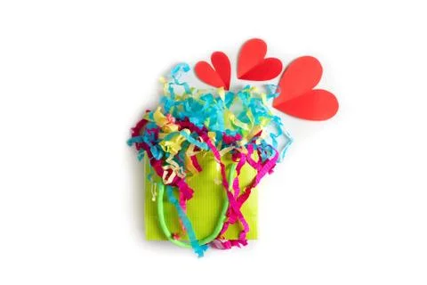 Paper bag with colored streamerst white background Red heart concept of Valen Stock Photos
