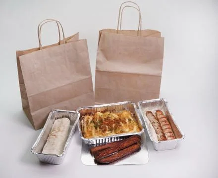 Paper bag, foil containers on an isolated white background. Food delivery Stock Photos
