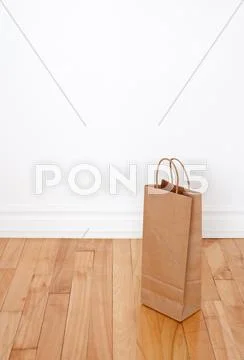 Paper bag on wooden floor Stock Photos