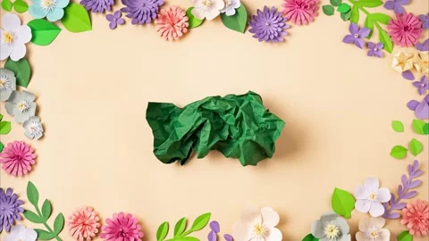A paper ball spreads making a blank sheet on floral background 스톡 동영상 170793848