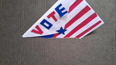 Paper ballot with vote text inserted into a secure cardboard box Stock Photos