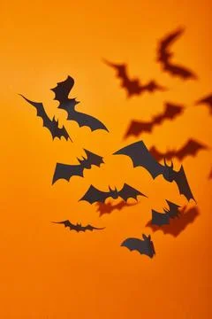 Paper bats shadow orange background Stock Photos