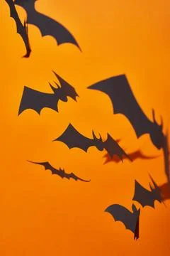Paper bats shadow orange background Stock Photos