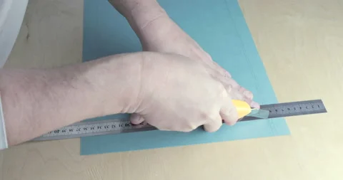 Paper being cut with razor blade and ruler close up Stock Footage 123017337