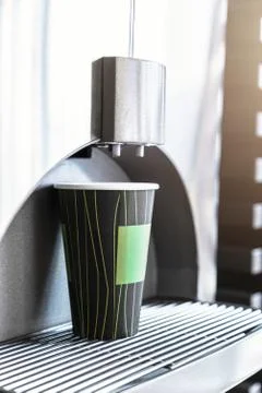 Paper bio cup stands on automatic coffee machine Stock Photos