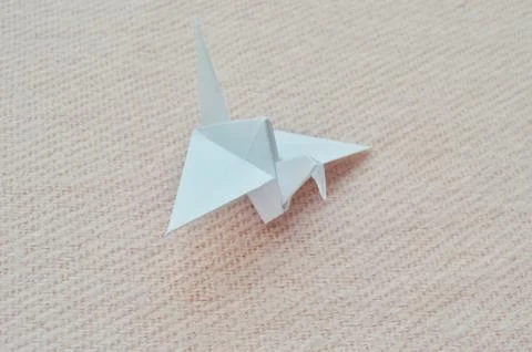 Paper bird step by step instructions. White paper on a pink background. Step  Stock Photos