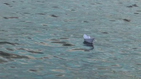 Paper boat bobs on the waves Stock Footage 64184424