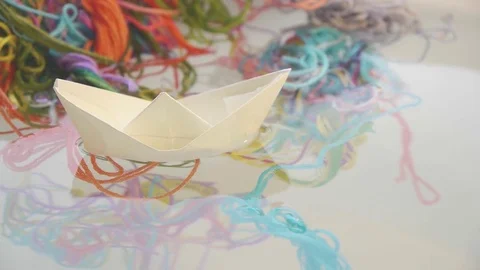 Paper boat with colored threads Stock Footage 75396106