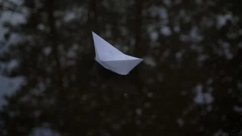 Paper boat floating in a puddle after rain. Stock Footage 155001064