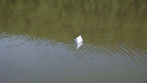 Paper boat floating on water Stock Footage 76167789