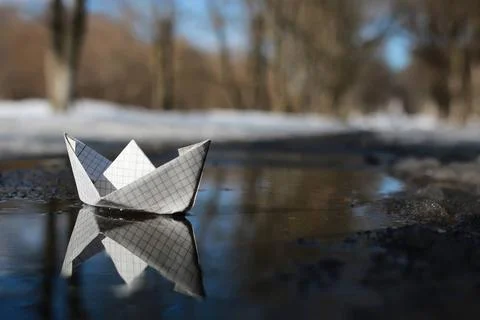 Paper boat in a pool various objects of the spring season in the best of t... Stock Photos